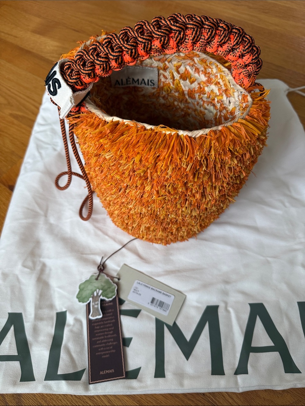 Alemais Orange Textured Fringe Bucket Bag with Braided Handle